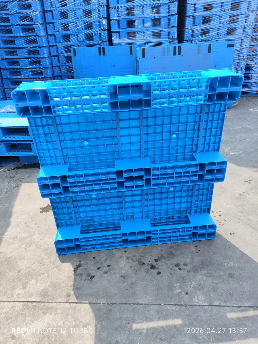 Stack of blue plastic pallets
